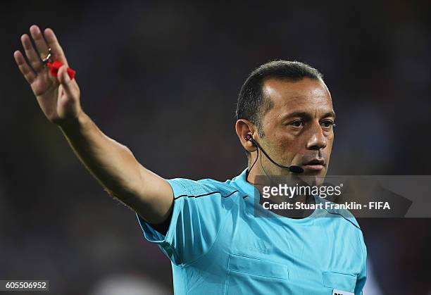 Referee Cuneyt Cakir gestures during the Olympic Men's Football match between Argentina and Algeria at Olympic Stadium on August 7, 2016 in Rio de...