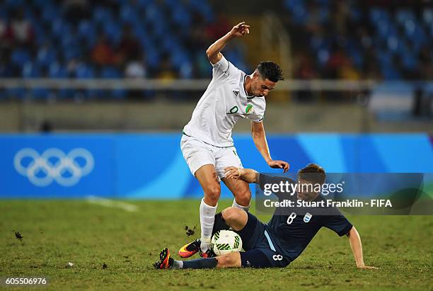 Santiago Ascacibar of Argentina is challenged by Mohammed Benkablia of Algeria during the Olympic Men's Football match between Argentina and Algeria...