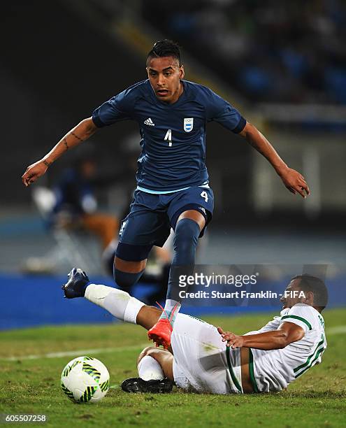 Jose Luis Gomez of Argentina is challenged by Zakarya Haddouche of Algeria during the Olympic Men's Football match between Argentina and Algeria at...