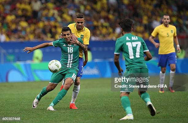 Luan Vieira of Brazil and Amped Attwan of Iraq challenge for the ball during the Men's First Round Group A match between Brazil and Iraq on Day 2 of...