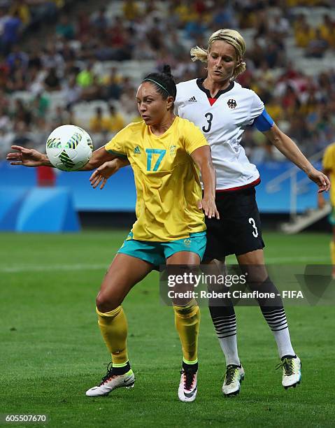 Kyah Simon of Australia is challenged by Saskia Bartusiak of Germany during the Women's First Round Group F match between Germany and Australia on...