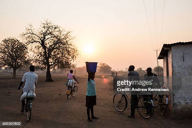 People walk and cycle in the village of Malikopo, which lies in one of the areas most affected by drought, on September 9, 2016 in Chikwawa, Malawi....