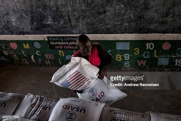 Bags of sorghum are distributed as aid in at a school in the village of Malikopo, which lies in one of the areas most affected by drought, on...