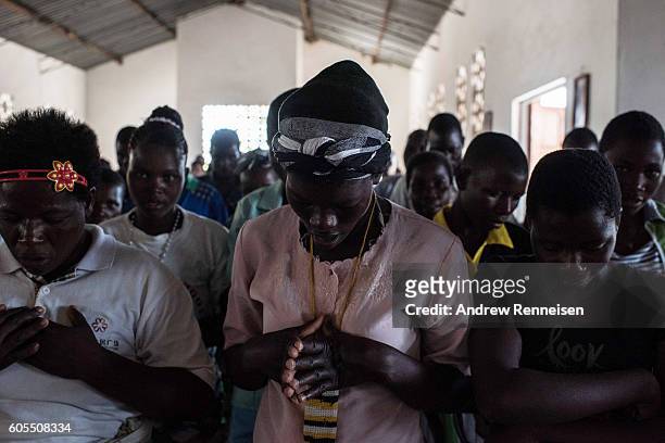 People gather for Sunday service at Mofolo Woyera church in the village of Mulele, which lies in one of the areas most affected by drought, on...