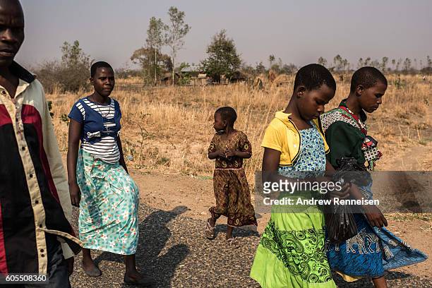 Members of the Majawa family walk to their church in the village of Mulele, which lies in one of the areas most affected by drought, on September 11,...