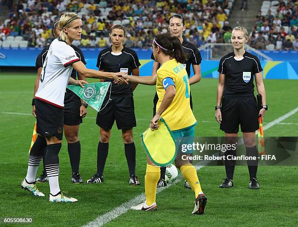 Saskia Bartusiak of Germany and Lisa de Vanna of Australia shakes hands for the start of the Women's First Round Group F match between Germany and...