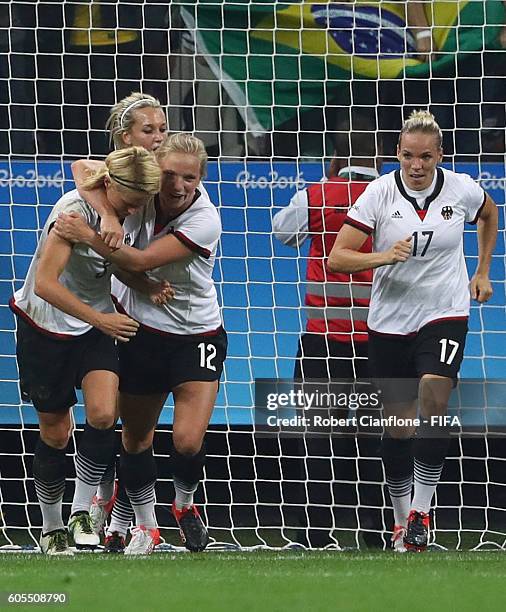 Saskia Bartusiak of Germany celebrates with team mates after scoring a goal during the Women's First Round Group F match between Germany and...