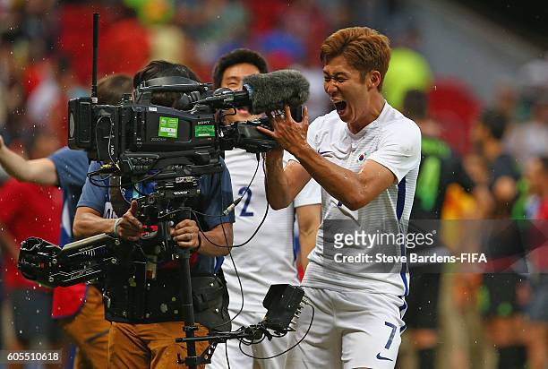 Heungmin Son of Korea Republic grabs the steadicam as he celebrates their victory over Mexico after the Men's First Round Group C match between Korea...