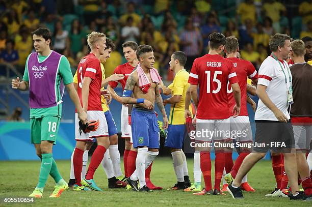 Players exchange their jersey after the Men's Football match between Denmark and Brazil on Day 5 of the Rio 2016 Olympic Games at Arena Fonte Nova on...
