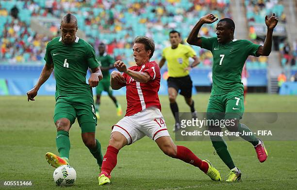 Casper Nielsen of Denmark competes for the ball with William Ekong of Nigeria during the Men's Football Quarter Final match between Nigeria and...
