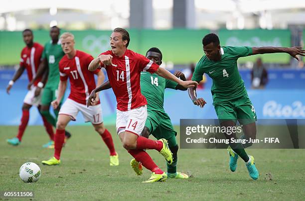 Casper Nielsen of Denmark competes for the ball with Abdullahi Shehu of Nigeria during the Men's Football Quarter Final match between Nigeria and...