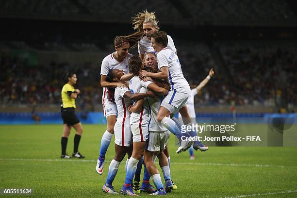 Carli Lloyd of USA celebrates with her team mates after scoring her team's first goal during Women's Group G match between USA and France on Day 1 of...