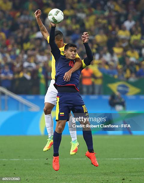 Teofilo Gutierrez of Colombia is challenged by Marquinhos of Brazil during the Men's Football Quarter Final match between Brazil and Colombia on Day...