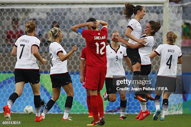 Sara Daebritz of Germany celebrates with her team mates after scoring her team's second goal during the Women's Semi Final match between Canada and...