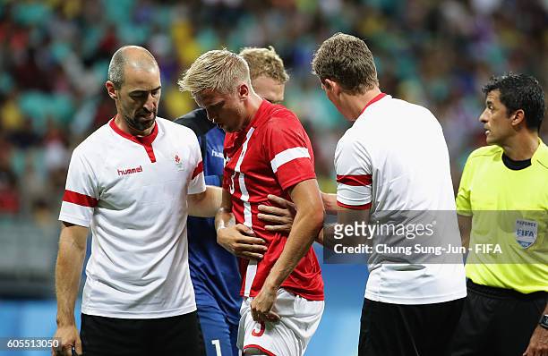 Kasper Larsen of Denmark is injured during the Men's Football Quarter Final match between Nigeria and Denmark on Day 8 of the Rio 2016 Olympic Games...