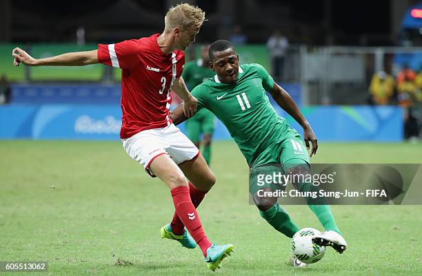 Kasper Larsen of Denmark competes for the ball with Oluwafemi Ajayi of Nigeria during the Men's Football Quarter Final match between Nigeria and...