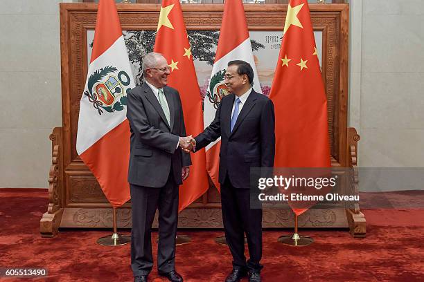 Chinese Premier Li Keqiang shakes hands with Peruvian President Pedro Pablo Kuczynski at the Great Hall of the People on September 14, 2016 in...