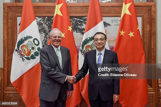 Chinese Premier Li Keqiang shakes hands with Peruvian President Pedro Pablo Kuczynski at the Great Hall of the People on September 14, 2016 in...