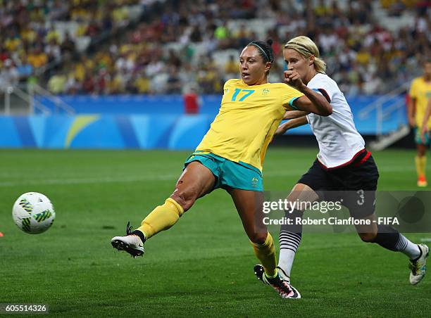 Kyah Simon of Australia is challenged by Saskia Bartusiak of Germany during the Women's First Round Group F match between Germany and Australia on...
