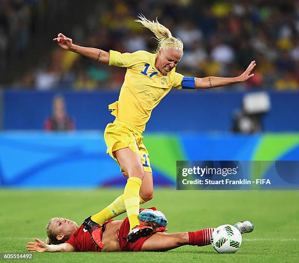 Leonie Maier of Germany is challenged by Caroline Seger of Sweden during the Olympic Women's Football final between Sweden and Germany at Maracana...