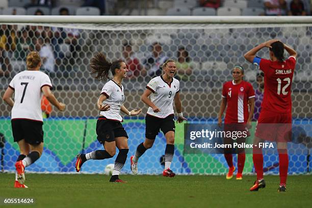 Sara Daebritz of Germany celebrates with her team mates after scoring her team's second goal during the Women's Semi Final match between Canada and...