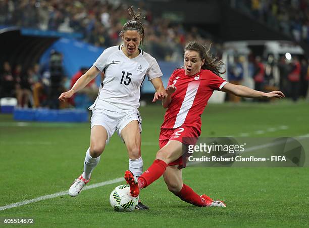 Elise Bussaglia of France is challenged by Allysha Chapman of Canada during the Women's Football Quarter Final match between Canada and France on Day...