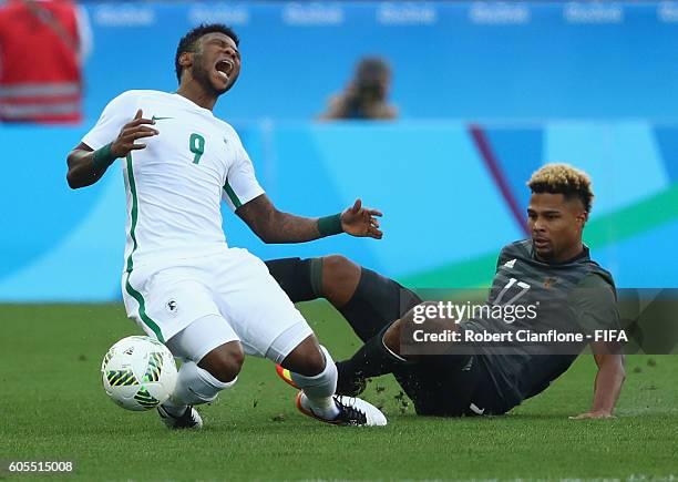 Imoh Ezekiel of Nigeria is fouled by Serge Gnabry of Germany during the Men's Football Semi Final between Nigeria and Germany on Day 12 of the Rio...