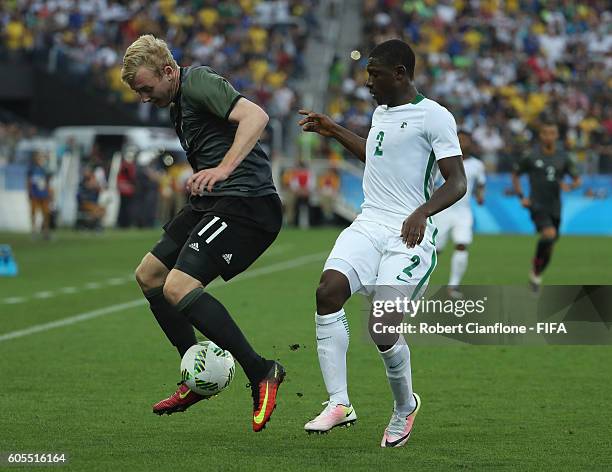 Julian Brandt of Germany is pressured by Muenfuh Sincere of Nigeria during the Men's Football Semi Final between Nigeria and Germany on Day 12 of the...