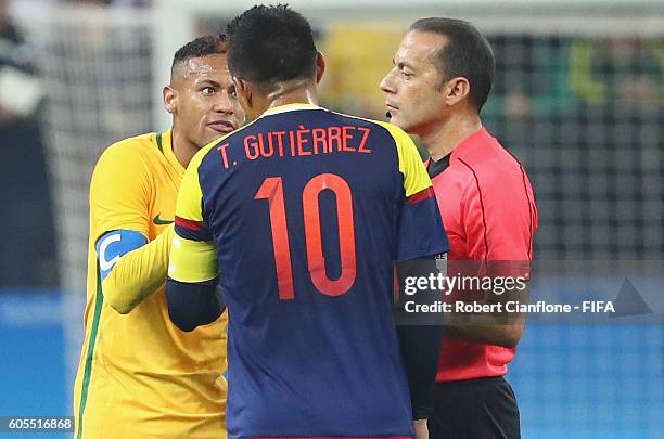 Neymar of Brazil and Teofilo Gutierrez of Colombia are spoken to by referee Cuneyt Cakir during the Men's Football Quarter Final match between Brazil...