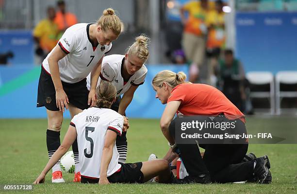 Annike Krahn of Germany is injured during the Women's Football Quarter Final match between China and Germany on Day 7 of the Rio 2016 Olympic Games...