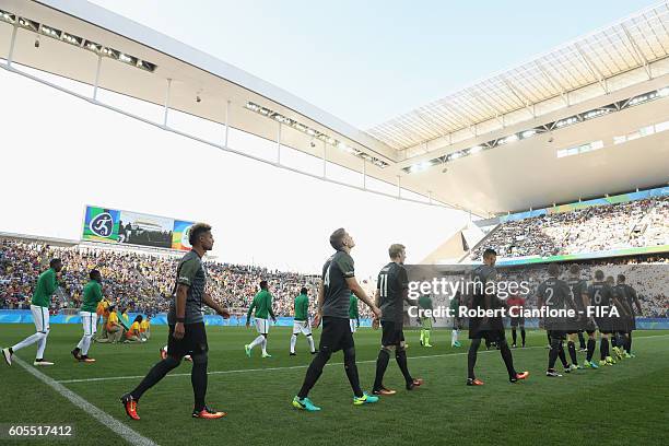 The teams walk out for the Men's Football Semi Final between Nigeria and Germany on Day 12 of the Rio 2016 Olympic Games at Arena Corinthians on...