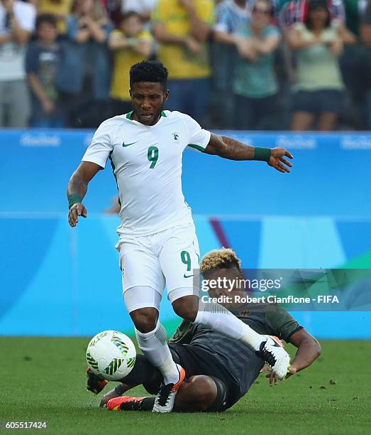 Imoh Ezekiel of Nigeria is fouled by Serge Gnabry of Germany during the Men's Football Semi Final between Nigeria and Germany on Day 12 of the Rio...