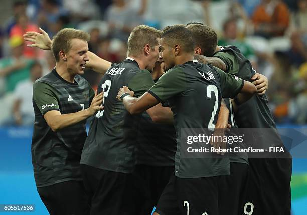 Nils Petersen of Germany celebrates with team mates after scoring a goal during the Men's Football Semi Final between Nigeria and Germany on Day 12...