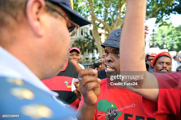 Economic Freedom Fighters members quarrel with police outside parliament during the National Assemblys President Jacob Zuma Question and Answer...