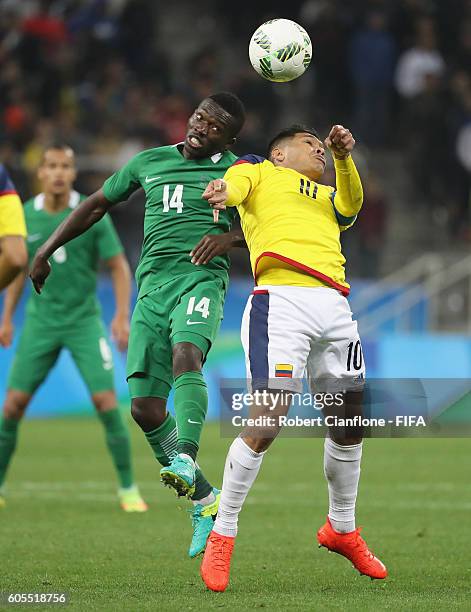 Okechukwu Azubuike of Nigeria and Teofilo Gutierrez of Colombia compete for the ball during the Men's First Round Group B match between Colombia and...