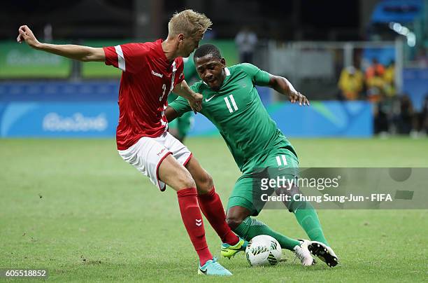 Kasper Larsen of Denmark competes for the ball with Oluwafemi Ajayi of Nigeria during the Men's Football Quarter Final match between Nigeria and...