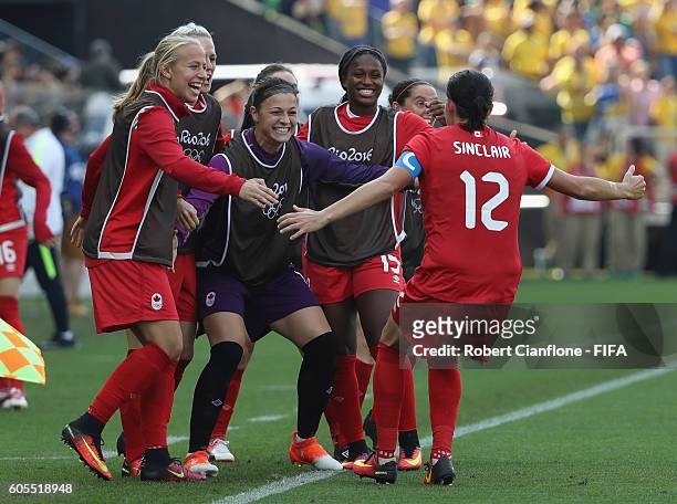 Christine Sinclair of Canada celebrates with team mates after scoring a goal during the Women's Football Bronze Medal match between Brazil and Canada...