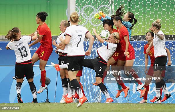 Saskia Bartusiak and Tabea Kemme of Germany compete for the ball with Rui Zhang, Lina Zhao and Haiyan Wu of China during the Women's Football Quarter...