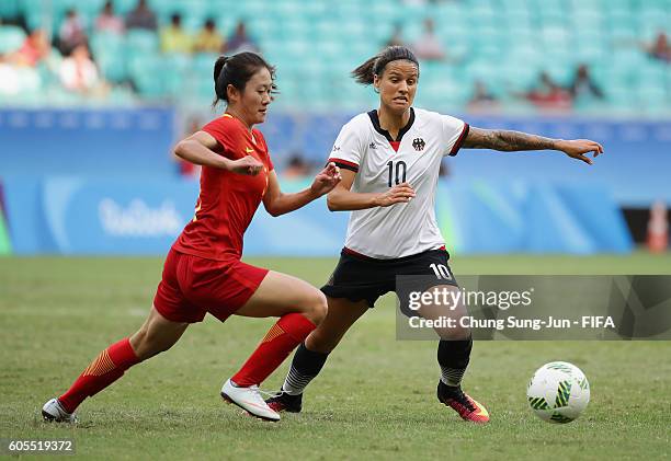 Dzsenifer Marozsan of Germany competes for the ball with Haiyan Wu of China during the Women's Football Quarter Final match between China and Germany...