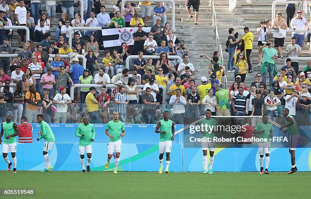 Nigeria warm up for the Men's Football Semi Final between Nigeria and Germany on Day 12 of the Rio 2016 Olympic Games at Arena Corinthians on August...