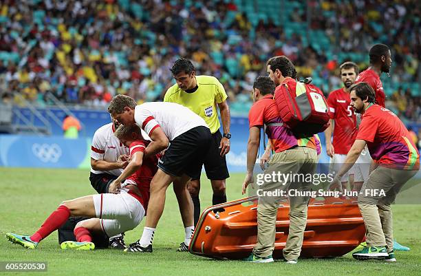 Kasper Larsen of Denmark is injured during the Men's Football Quarter Final match between Nigeria and Denmark on Day 8 of the Rio 2016 Olympic Games...