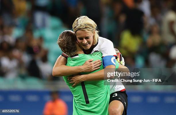 Saskia Bartusiak of Germany celebrates with Almuth Schult victory over the China after the Women's Football Quarter Final match between China and...