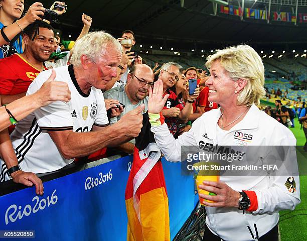 Silvia Neid, head coach of Germany celebrates with fans after winning the Olympic Women's Football final between Sweden and Germany at Maracana...