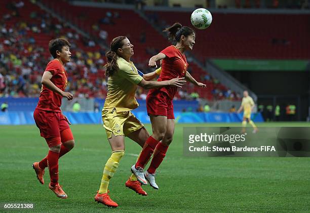 Haiyan Wu of China PR heads the ball away from Lotta Schelin of Sweden during the Women's First Round Group E match between China PR and Sweden on...