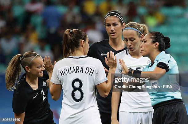 Ria Percival of New Zealand and Jessica Houara of France talk with referee Lucila Venegas during the Women's Football match between New Zealand and...