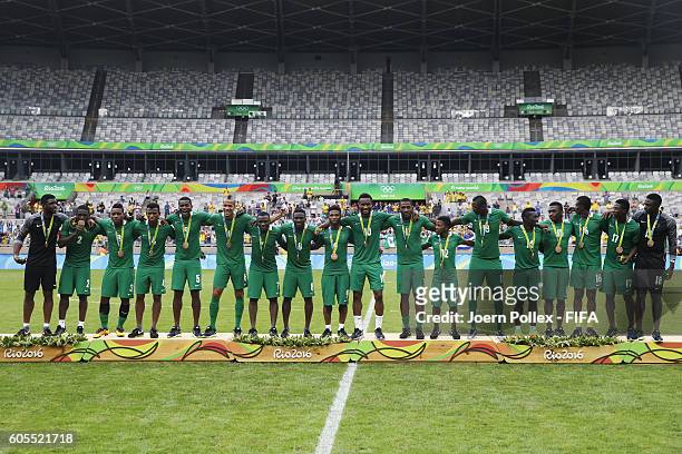 Nigerian team celebrates with their medals following victory during the Men's Olympic Football Bronze Medal match between Honduras and Nigeria at...