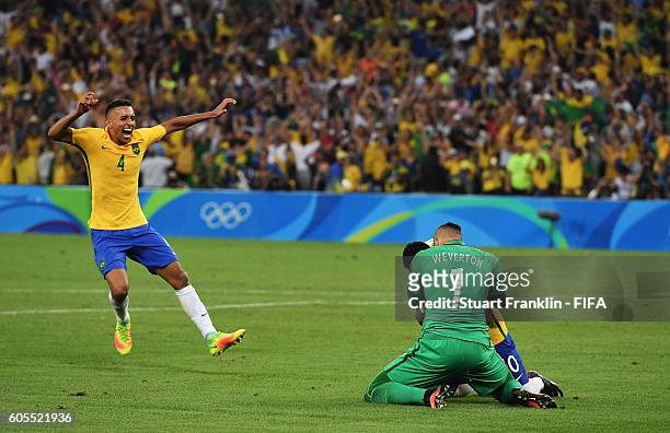 Neymar of Brazil celebrates after scoring the winning penalty with Weverton at the Olympic Men's Final Football match between Brazil and Germany at...