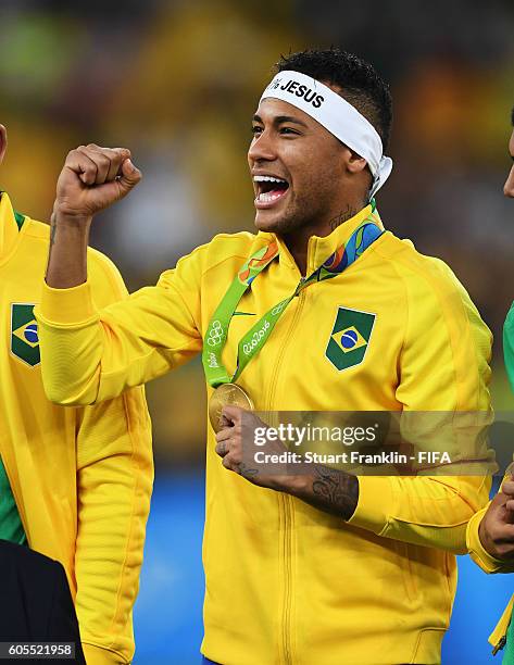 Neymar of Brazil recieves his gold medal at the Olympic Men's Final Football match between Brazil and Germany at Maracana Stadium on August 20, 2016...