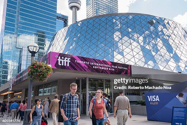 General view of the Toronto International Film Festival, TIFF. Sign at the Roy Thompson Hall and people enjoying the event in daytime.