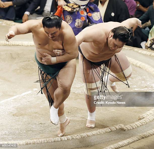 Top-ranked maegashira Okinoumi and ozeki Terunofuji try not to step out of the ring on the fourth day of the Autumn Grand Sumo Tournament at Ryogoku...
